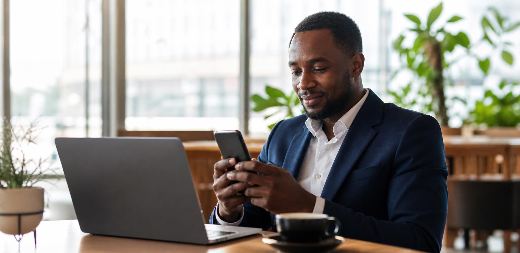 Professional using a mobile service naturally in a premium bright workspace